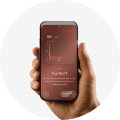Hand holding a phone showing the Hims app