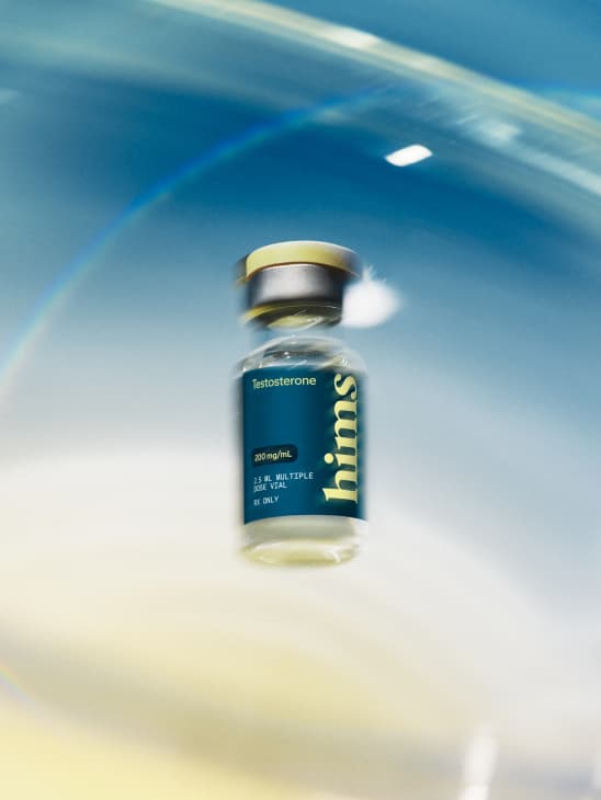 Hims testosterone vial on a blue backdrop