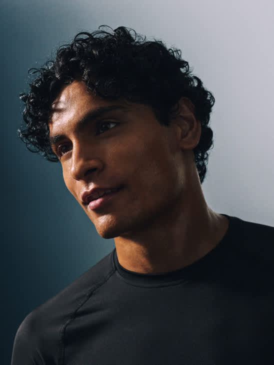 Man in a black T-shirt looking to the side